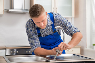 Handyman fixing faucet